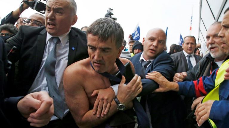 A shirtless Xavier Broseta (2ndL), Executive Vice President for Human Resources and Labour Relations at Air France, is evacuated by security after employees interrupted a meeting with representatives staff at the Air France headquarters building at the Charles de Gaulle International Airport in Roissy, near Paris, France, October 5, 2015. Air France confirmed in a meeting with staff on Monday that it plans to cut 2,900 jobs by 2017 and shed 14 aircraft from its long-haul fleet as part of efforts to lower costs, two union sources said.     REUTERS/Jacky Naegelen  TPX IMAGES OF THE DAY - RTS33IB