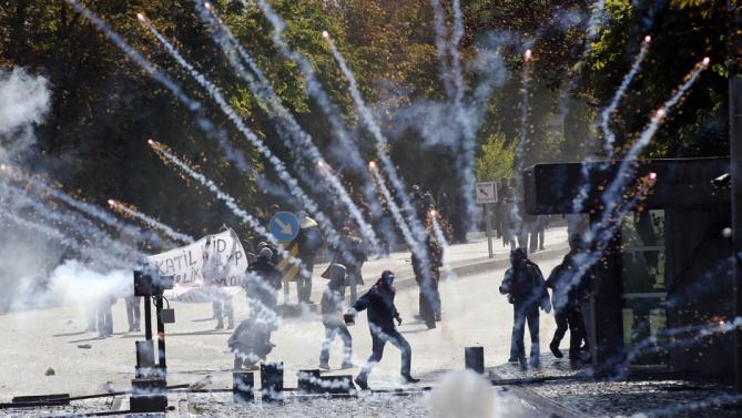 Demonstrators clash with riot police outside of the Middle Eastern Technical University (METU) in Ankara on October 9, 2014 to denounce Turkey's unwillingness to intervene militarely against Islamic State (IS) forces in the Syrian town of Ain al-Arab, known as Kobane by the Kurds. Deadly protests in Turkey over the government's policy on Islamic State (IS) militants are aimed at sabotaging the fragile peace process between Kurdish rebels and Ankara, Turkish President Recep Tayyip Erdogan said on October 9.   AFP PHOTO/ADEM ALTAN