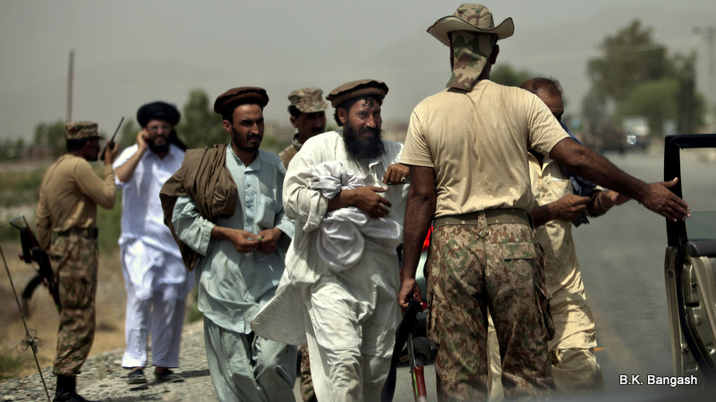 Pakistani army troops allow tribal people to travel to north Waziristan after a clearance at a check post outside Bannu, Pakistan, Wednesday, June 18, 2014. T